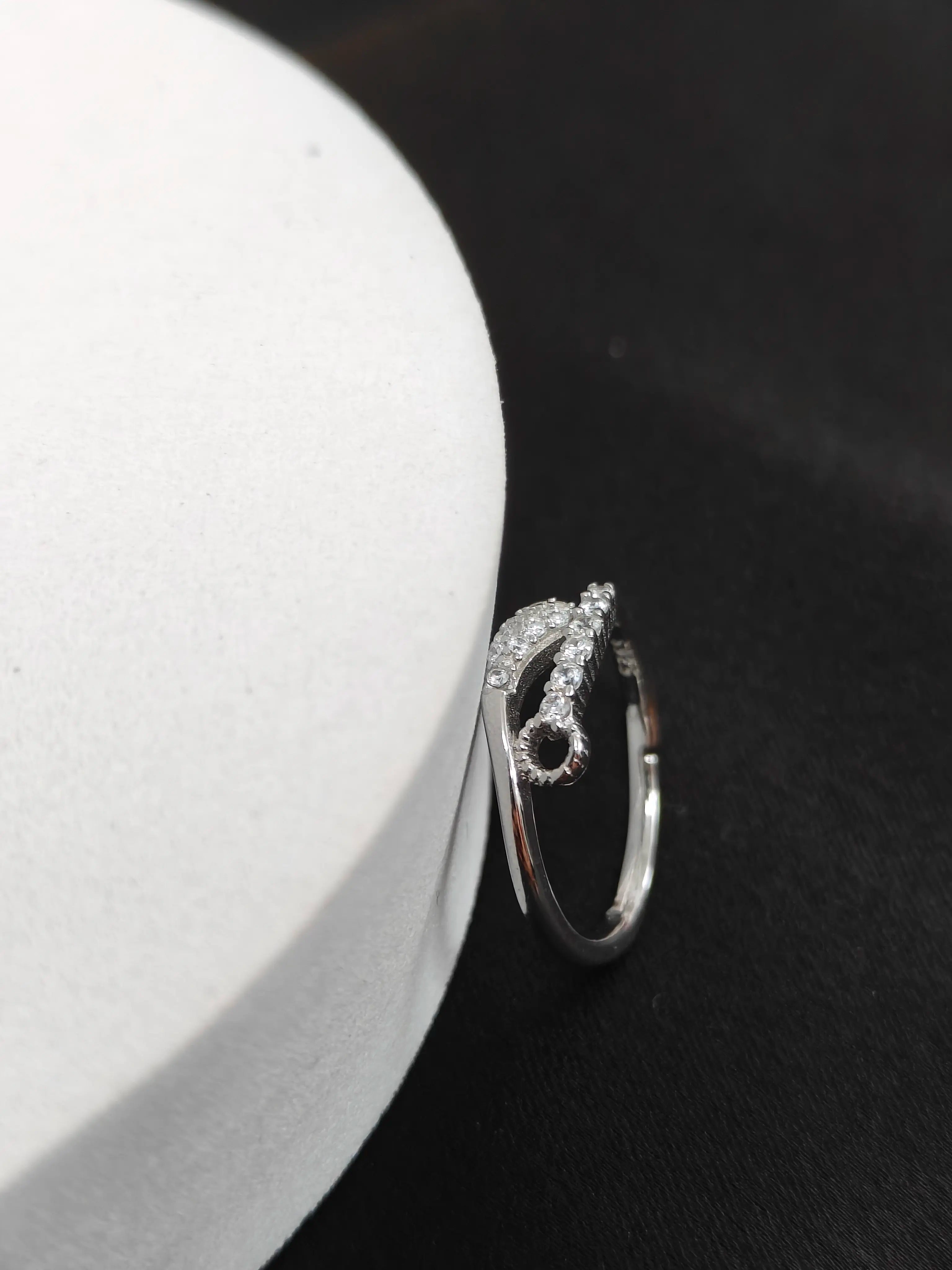 Silver ring with a unique design on a dark surface